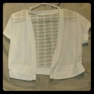 White cardigan with a lacey back.
